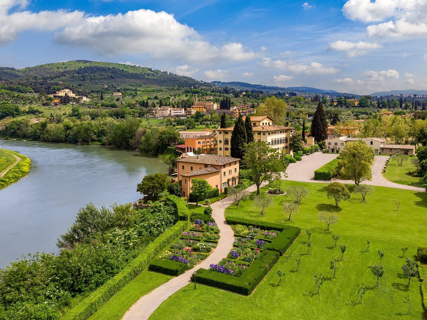 Aerial view of Villa La Massa on the banks of the Arno, surrounded by gardens and Tuscan hills